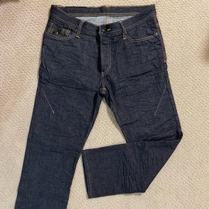Rogue men’s dark denim jeans with button fly and leather detailing.  Size 32